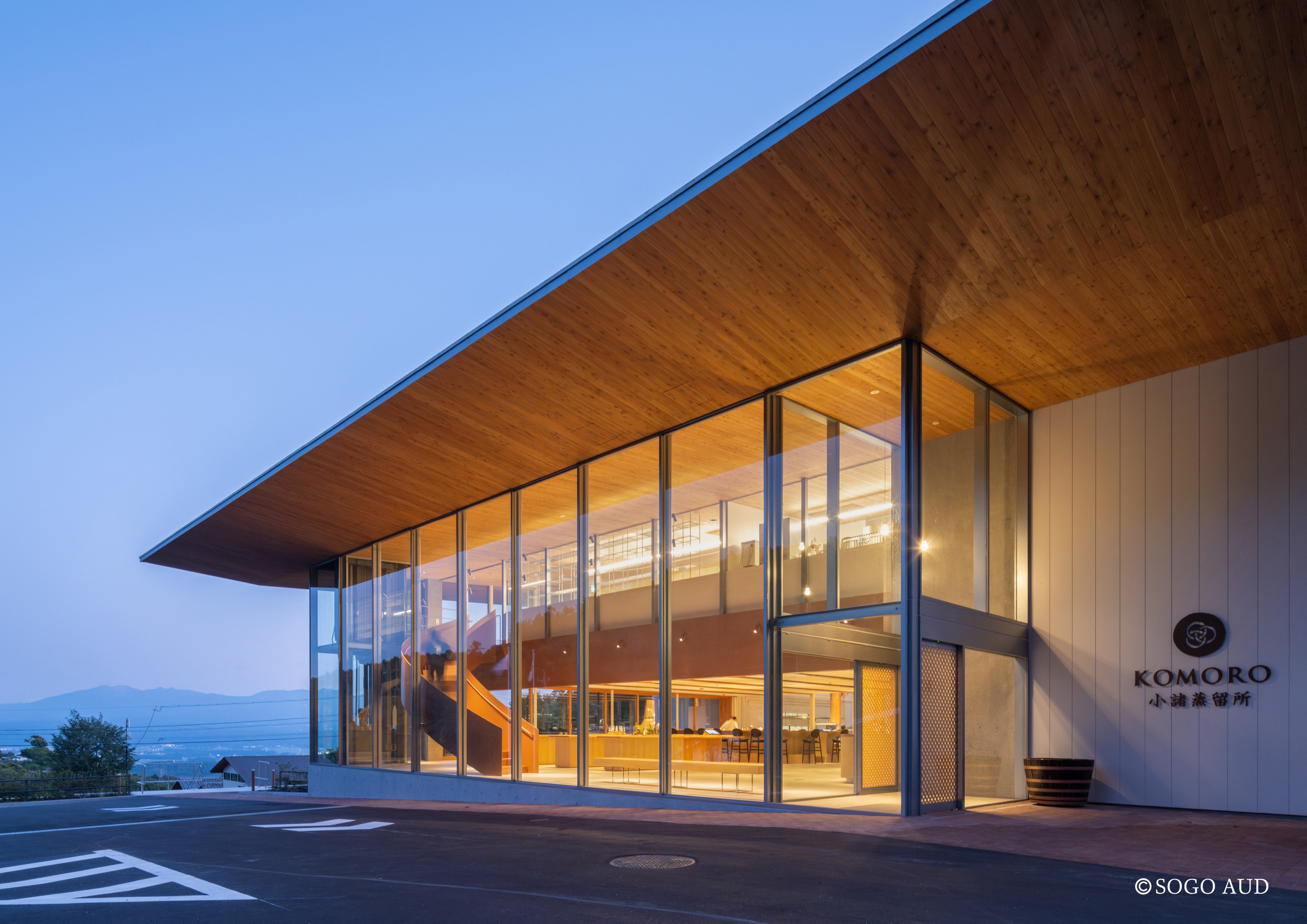 Floor-to-ceiling windows mark the modern exterior of Komoro Distillery